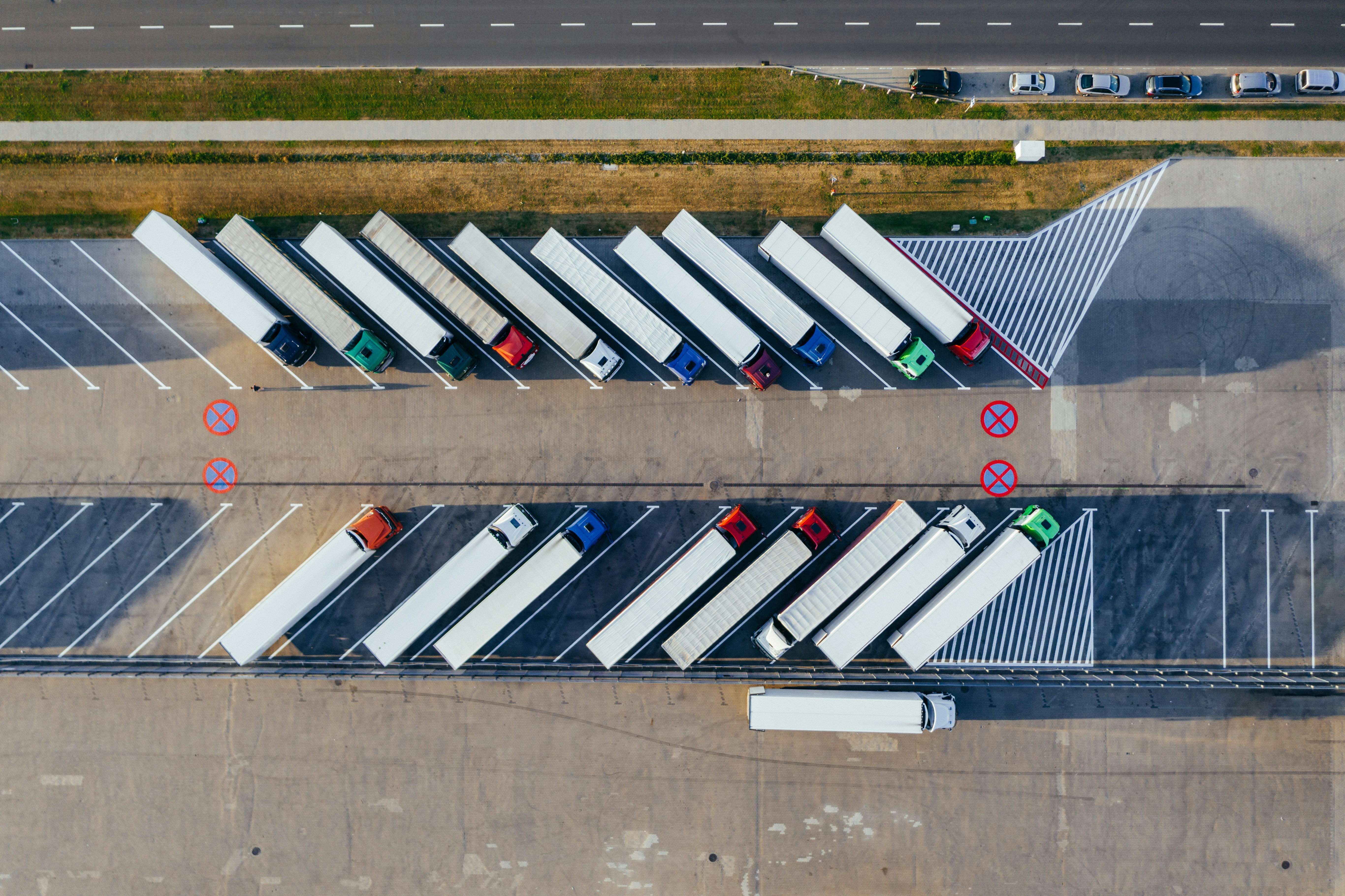 Multiple trucks parked, awaiting directions from a Freight Broker