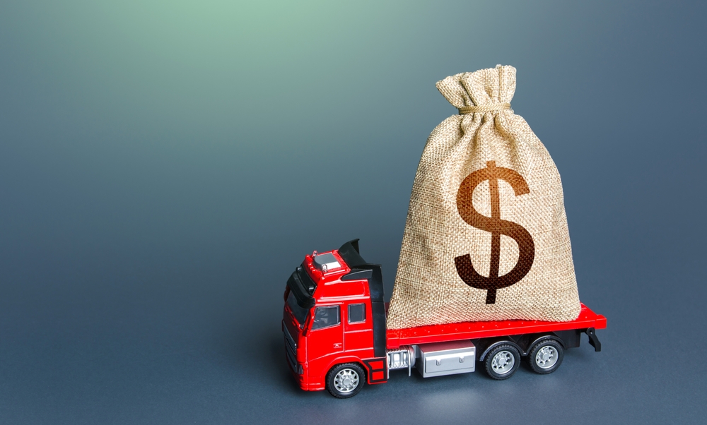 A bag of money laying on a truck bed