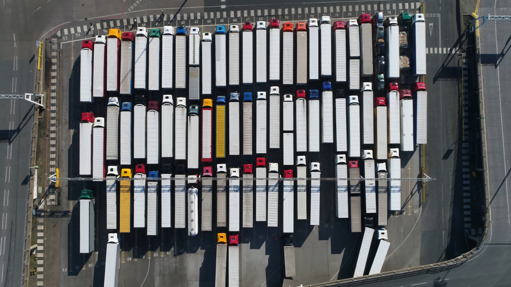 A fleet of trucks stationed in their yard.