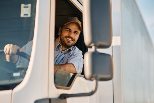 happy truck driver driving his truck