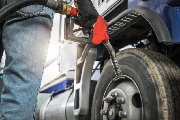 trucking industry driver filing their tractor truck, using their fuel card